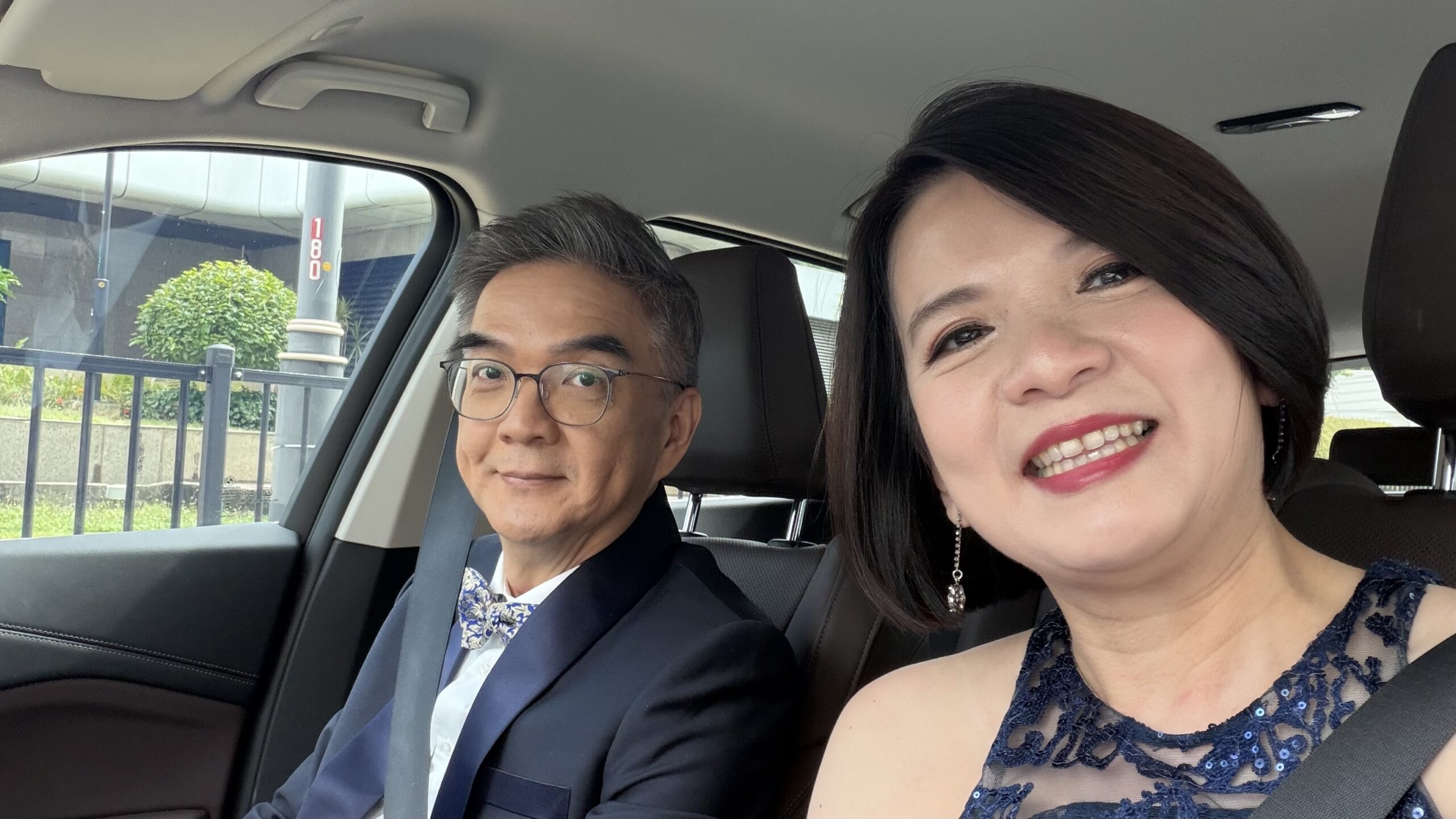 Two attendees dressed for the gala, photographed together in a car.